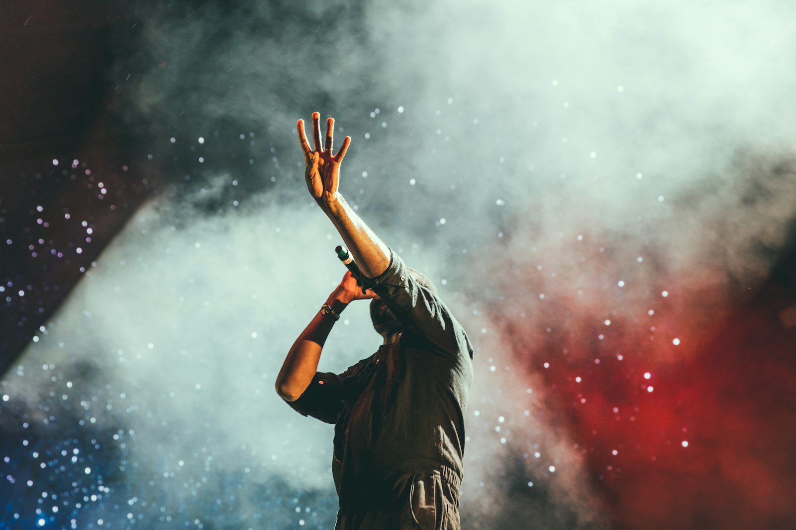 Worship leader on a concert stage - Praise as a spiritual weapon, praise lyrics meaning